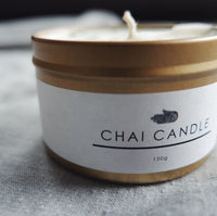 The Chai Walli Chai Candle golden jar without the lid on and the wick showing