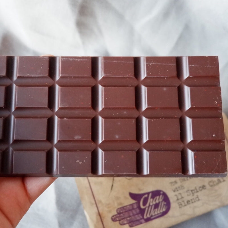 The Chai Walli  Chai Chocolate bar placed on top of its wrapper